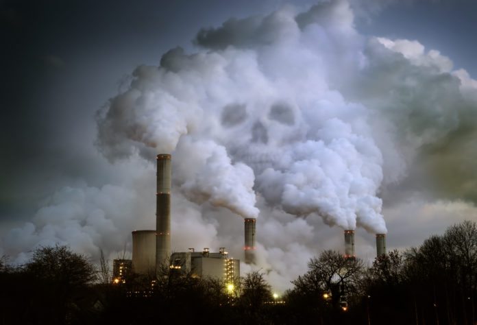 Power Plant Billowing Smoke in Shape of Skull