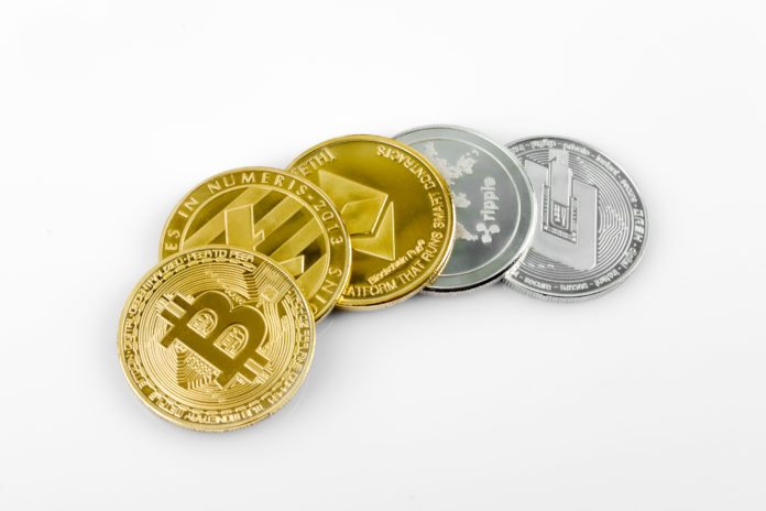Golden and silver crypto moneys on white background